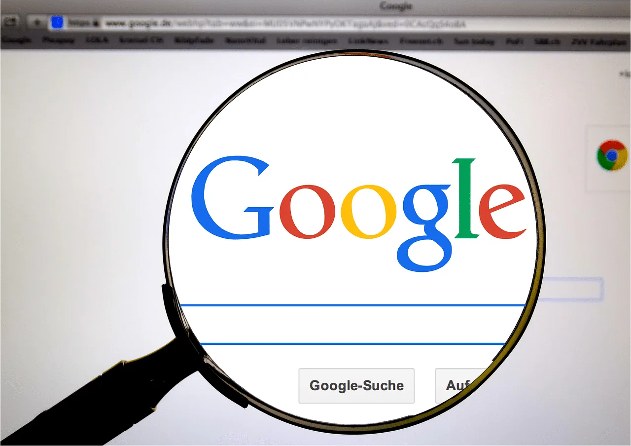 A magnifying glass enlarging the Google logo on a search page