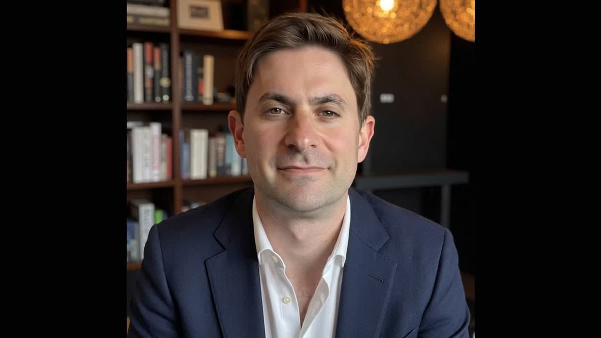 Ari Perler, Roku head of content strategy, seated in front of a bookshelf