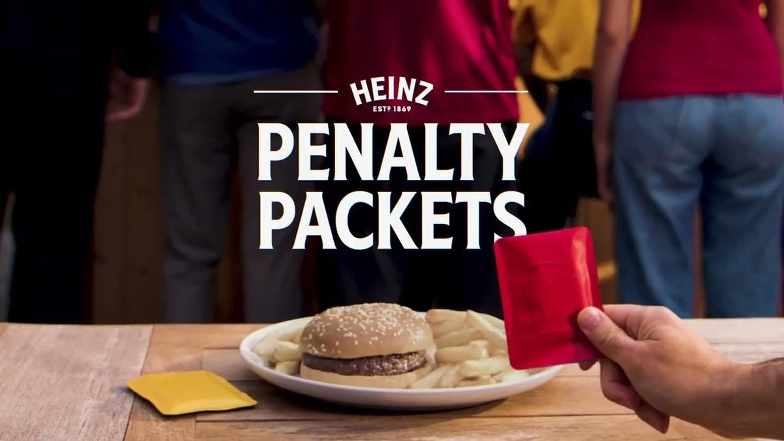 Heinz Penalty Packets campaign showing red card shaped ketchup sachet beside a burger and fries
