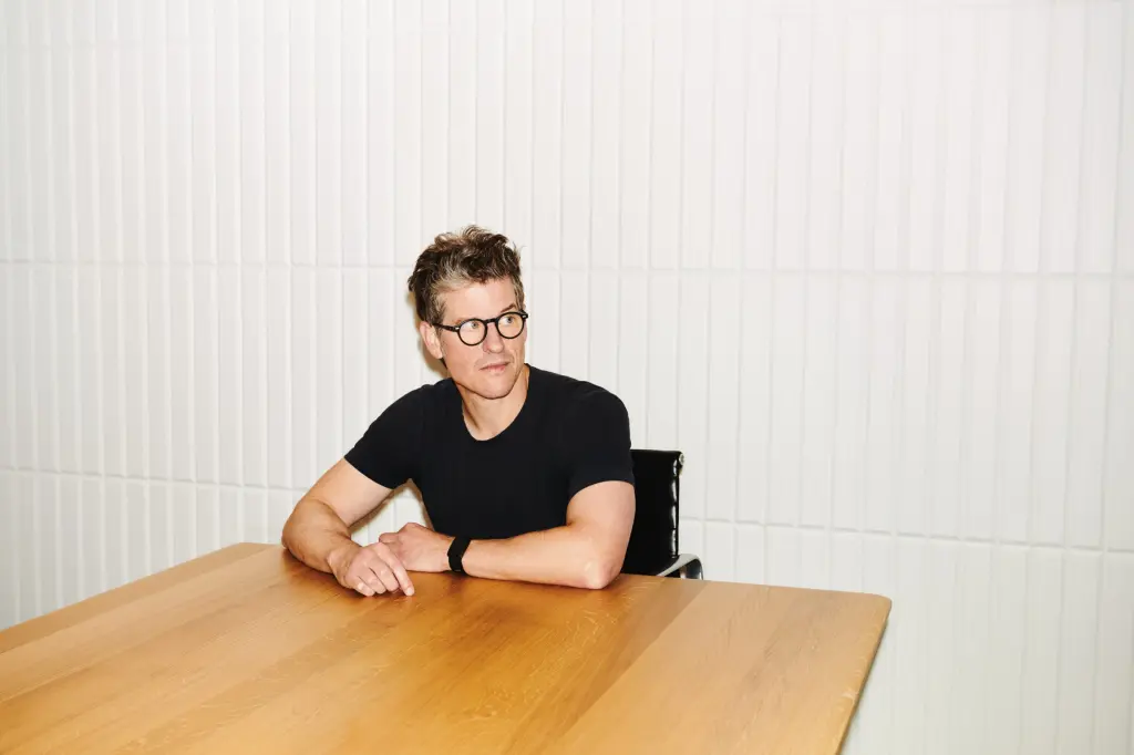 Fragment co-founder and CEO Thomas Neckel sitting at a wooden table