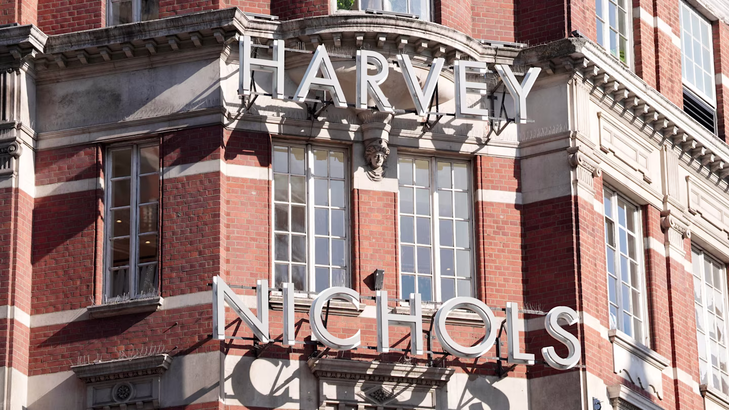 Close-up of the Harvey Nichols storefront signage on a red brick building facade