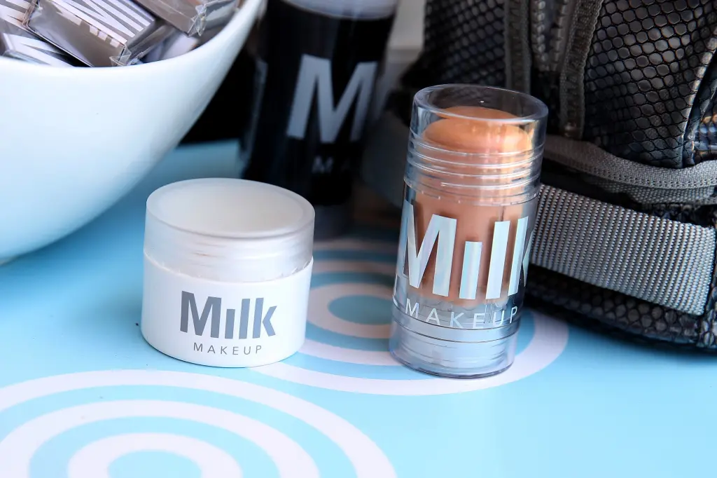 Milk Makeup product packaging, a jar and a stick foundation, displayed on a retail counter