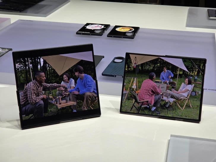 Samsung folding phones on display at an exhibition stand showing camping lifestyle imagery