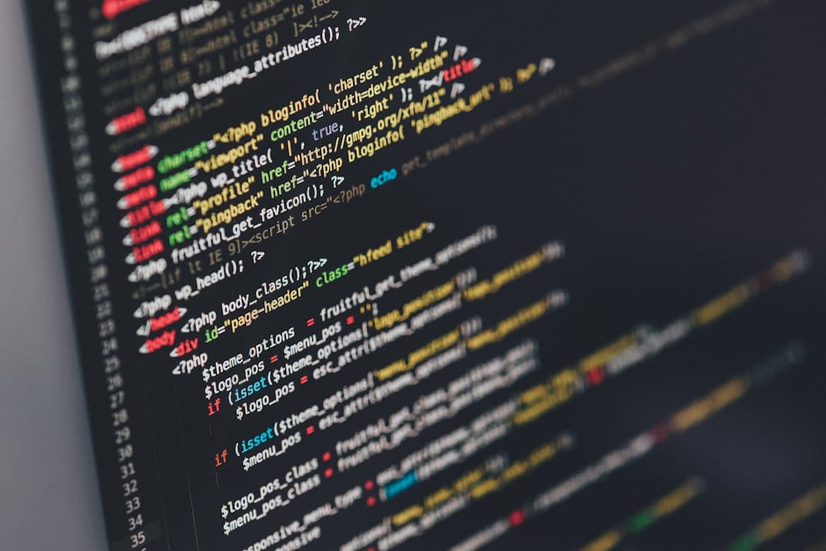 Close up of colorful website source code on a dark screen